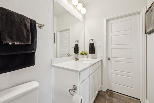 bathroom with tile patterned floors, toilet, and vanity