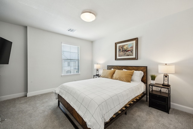carpeted bedroom featuring baseboards and visible vents
