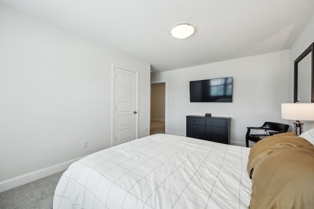 bedroom with carpet flooring and baseboards