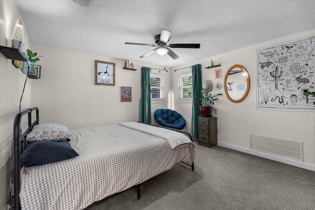 carpeted bedroom with visible vents, ceiling fan, and baseboards