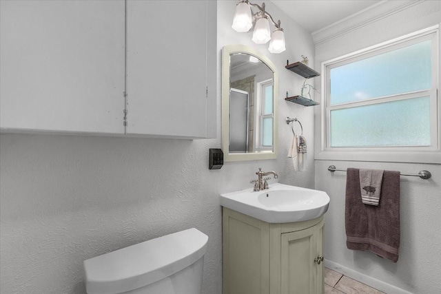bathroom with toilet, a shower with shower door, tile patterned flooring, and vanity