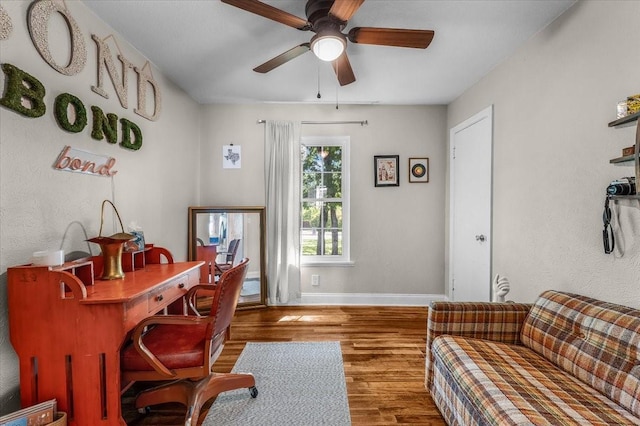 office featuring baseboards, wood finished floors, and ceiling fan
