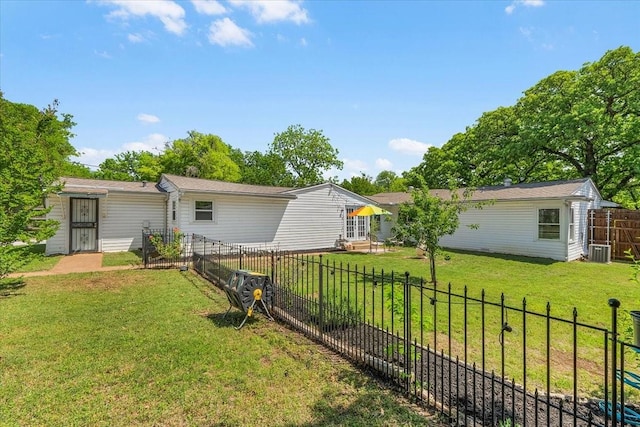 back of property featuring central AC, a fenced backyard, and a lawn