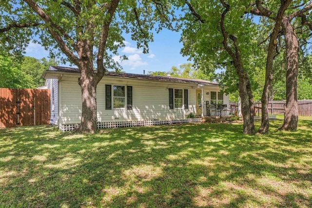 ranch-style home featuring a front yard and fence