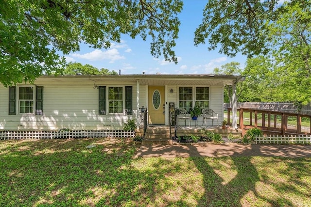 single story home with a porch, a front yard, and fence