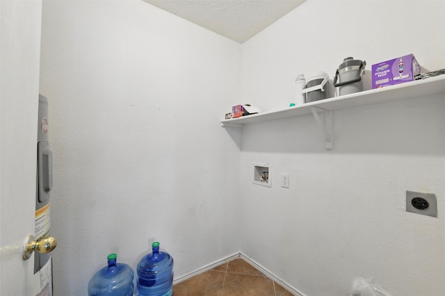 laundry room featuring hookup for a washing machine, laundry area, electric dryer hookup, tile patterned floors, and baseboards