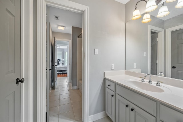 bathroom featuring baseboards, visible vents, tile patterned flooring, and vanity