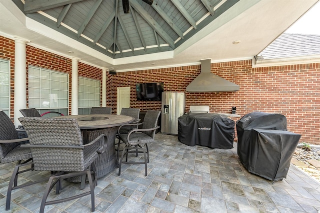 view of patio with outdoor dining space, a gazebo, and area for grilling