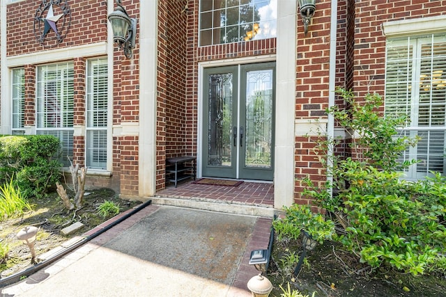 property entrance with french doors and brick siding