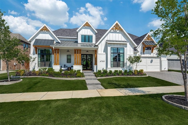 modern inspired farmhouse featuring a front yard, a standing seam roof, board and batten siding, and a porch