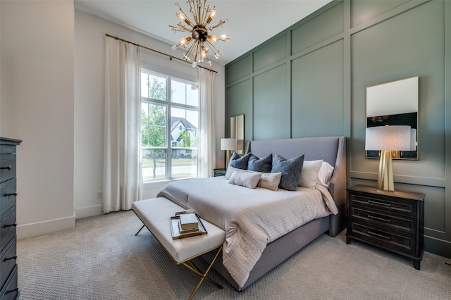 bedroom featuring an inviting chandelier, light colored carpet, and baseboards