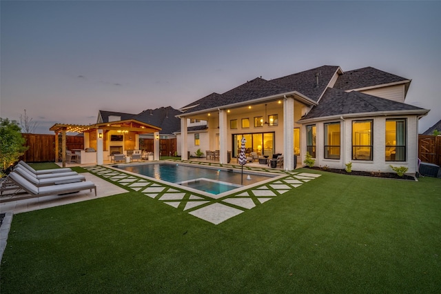 rear view of house with outdoor dry bar, a patio area, and a fenced backyard