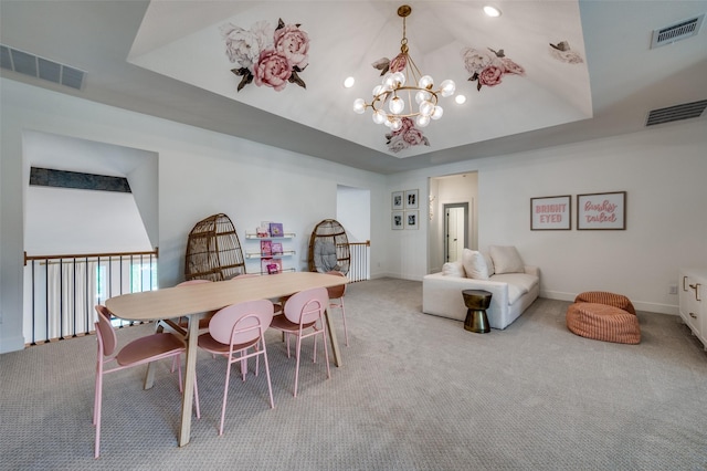 dining room with a notable chandelier, visible vents, and carpet floors