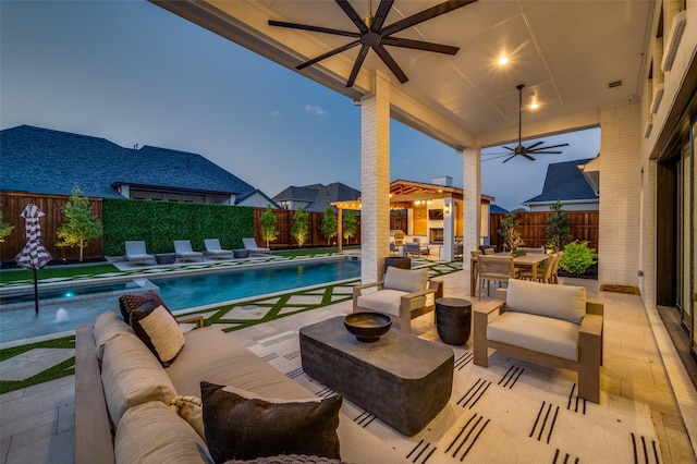 view of pool featuring a patio area, a fenced in pool, a fenced backyard, a ceiling fan, and an outdoor hangout area