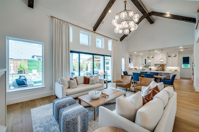 living room featuring beamed ceiling, an inviting chandelier, recessed lighting, light wood finished floors, and high vaulted ceiling