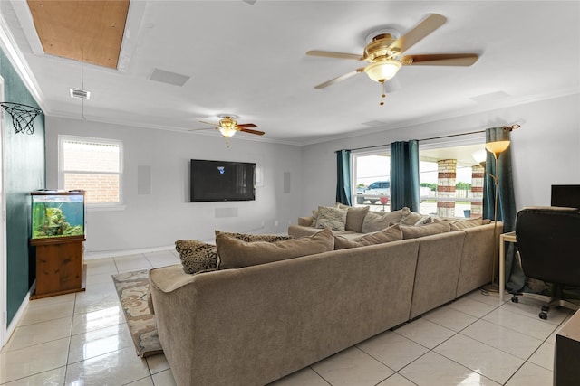 living area featuring ornamental molding, a ceiling fan, and a healthy amount of sunlight