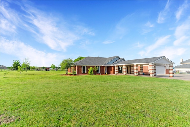 ranch-style house with concrete driveway, a front yard, a garage, and brick siding