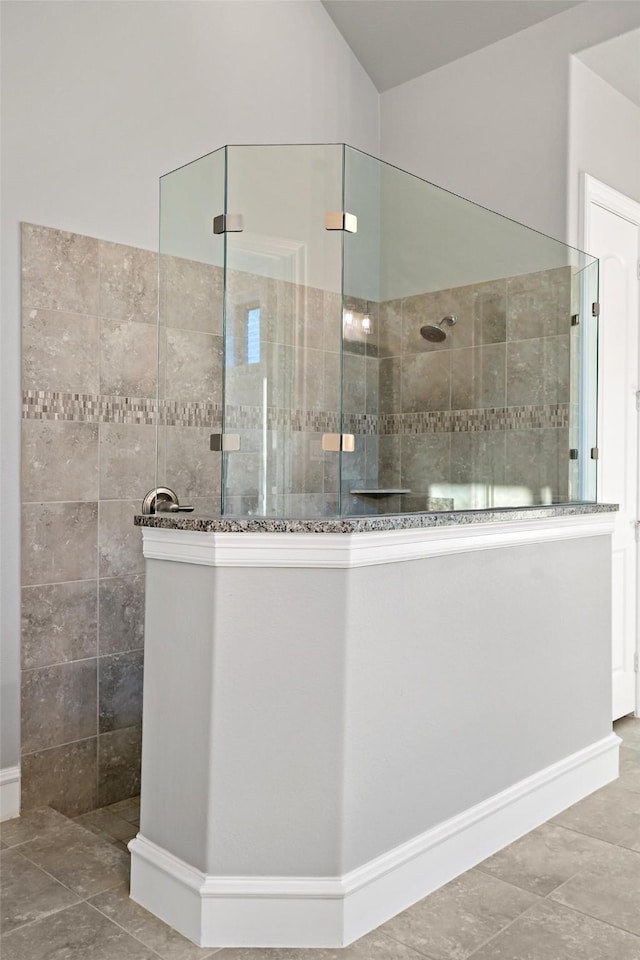 full bath with walk in shower, tile patterned flooring, and vaulted ceiling