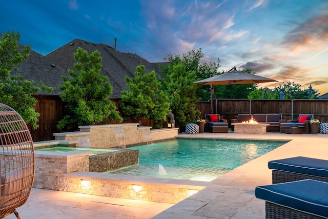 view of pool with a patio, a fenced in pool, an in ground hot tub, an outdoor living space with a fire pit, and fence