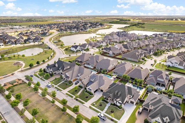 drone / aerial view featuring a residential view and a water view
