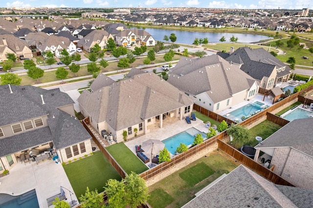 drone / aerial view featuring a residential view and a water view