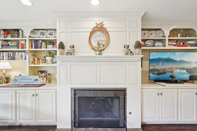 details featuring a fireplace with flush hearth and crown molding