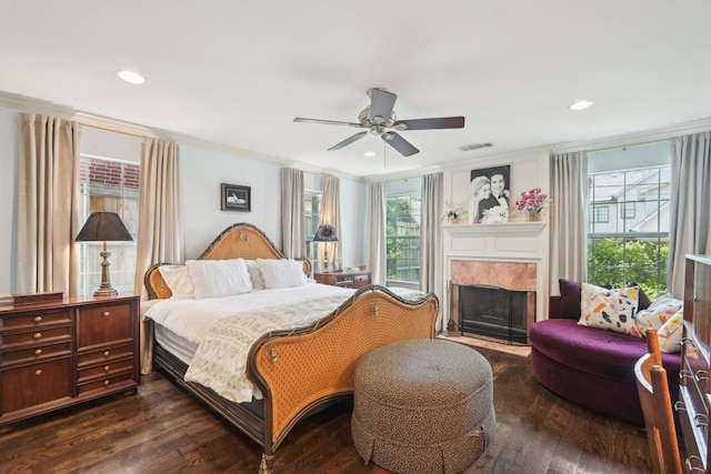 bedroom with recessed lighting, a premium fireplace, ceiling fan, visible vents, and dark wood finished floors