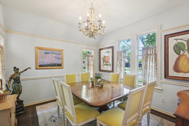 dining room with baseboards, wood finished floors, an inviting chandelier, and vaulted ceiling