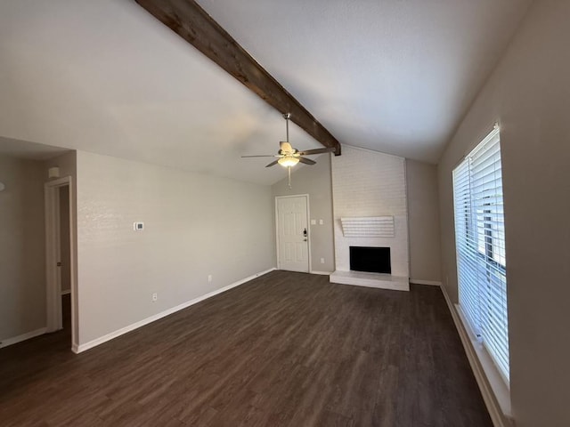 unfurnished living room with lofted ceiling with beams, baseboards, dark wood finished floors, a fireplace, and a ceiling fan
