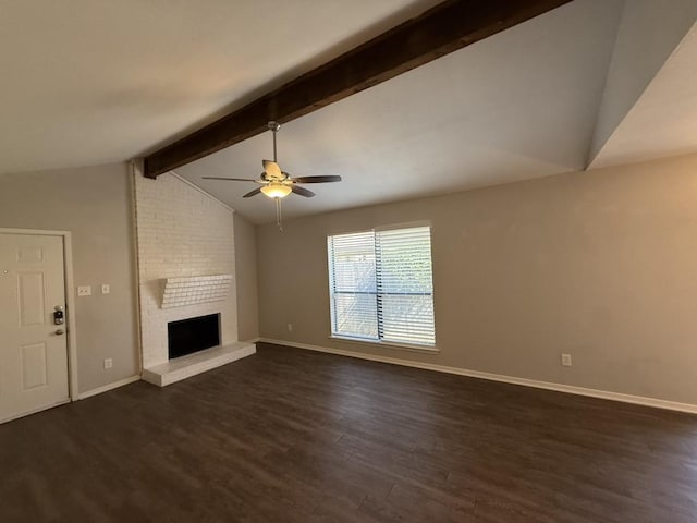 unfurnished living room featuring a fireplace, lofted ceiling with beams, ceiling fan, baseboards, and dark wood finished floors