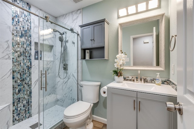 full bathroom featuring visible vents, a marble finish shower, toilet, and vanity