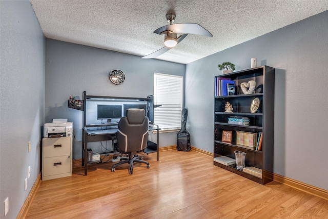 office with a textured ceiling, ceiling fan, wood finished floors, and baseboards