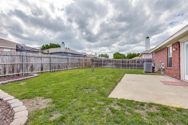 view of yard featuring a patio, a fenced backyard, and central AC unit
