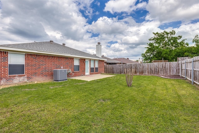 view of yard featuring central AC, a patio area, and a fenced backyard