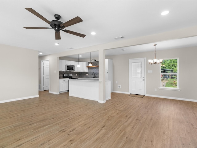 4451 Hardy St, Fort Worth, TX 76106 - unfurnished living room with ceiling fan with notable chandelier, recessed lighting, light wood finished floors, and baseboards
