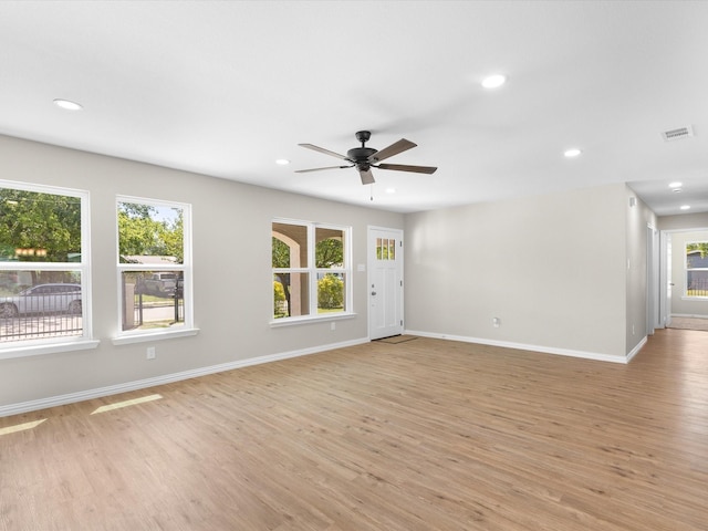 4451 Hardy St, Fort Worth, TX 76106 - unfurnished living room with a ceiling fan, visible vents, light wood-style flooring, and a healthy amount of sunlight