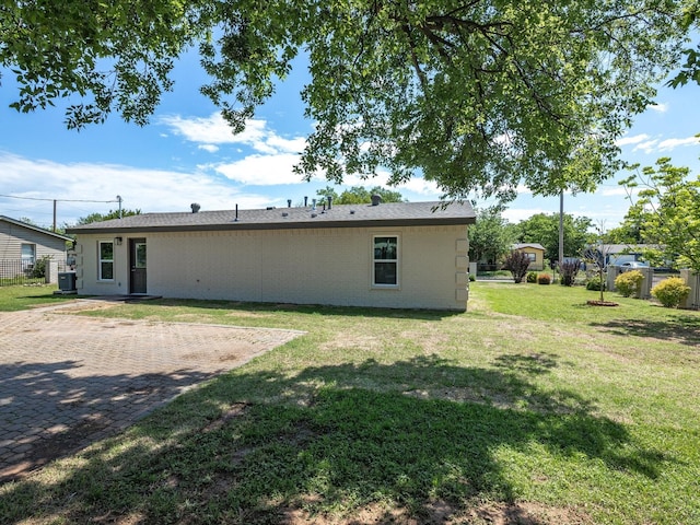 4451 Hardy St, Fort Worth, TX 76106 - back of house featuring a yard, central AC unit, and fence