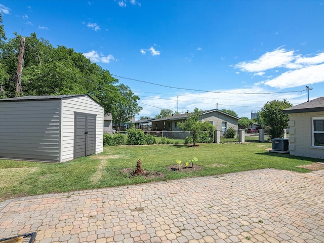 4451 Hardy St, Fort Worth, TX 76106 - view of patio / terrace with fence, a storage shed, central air condition unit, and an outbuilding
