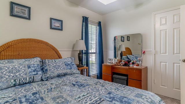 carpeted bedroom with a skylight