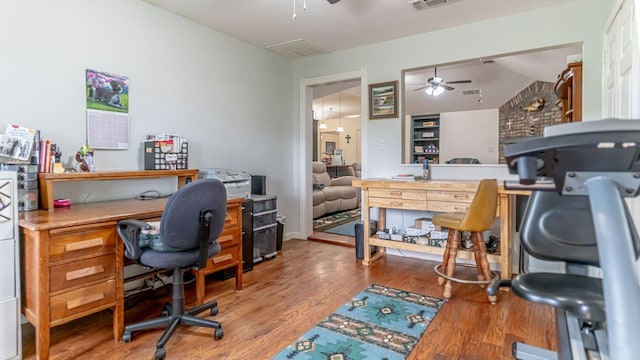 office space featuring ceiling fan, wood finished floors, and visible vents