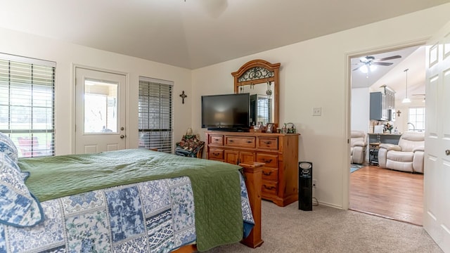 carpeted bedroom featuring vaulted ceiling and baseboards