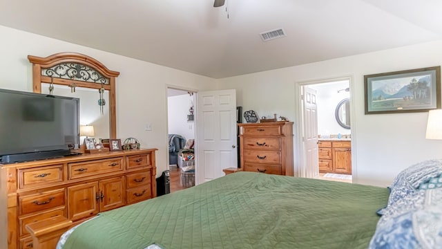 bedroom featuring visible vents, ceiling fan, and ensuite bath