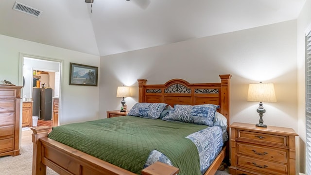 bedroom featuring connected bathroom, vaulted ceiling, light carpet, ceiling fan, and visible vents