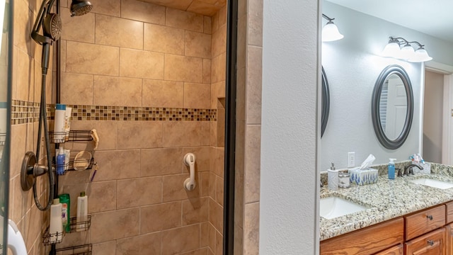 full bath featuring a shower stall, double vanity, and a sink