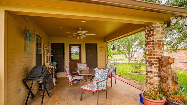 view of patio with fence and a ceiling fan