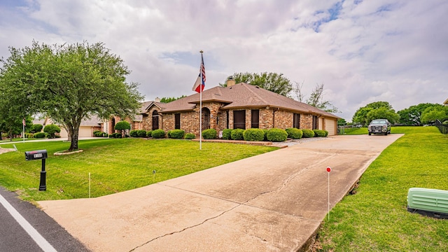 view of front of home with a front lawn, concrete driveway, and brick siding