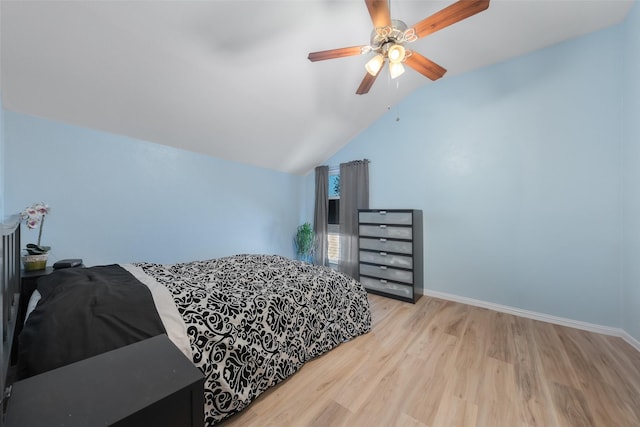 bedroom with lofted ceiling, wood finished floors, a ceiling fan, and baseboards
