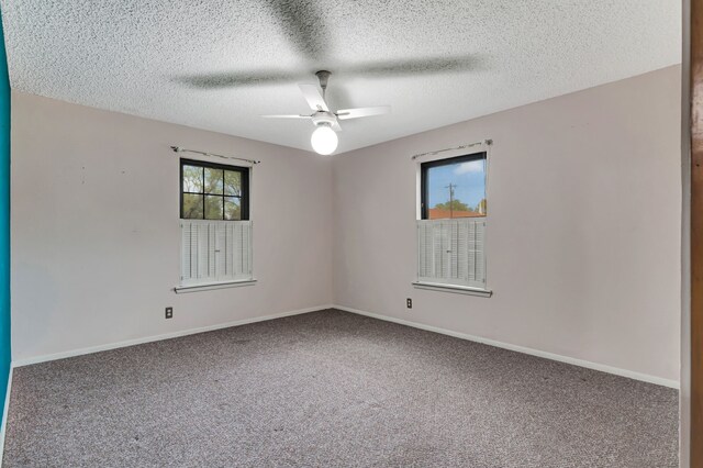 unfurnished room with a textured ceiling, ceiling fan, carpet, and baseboards