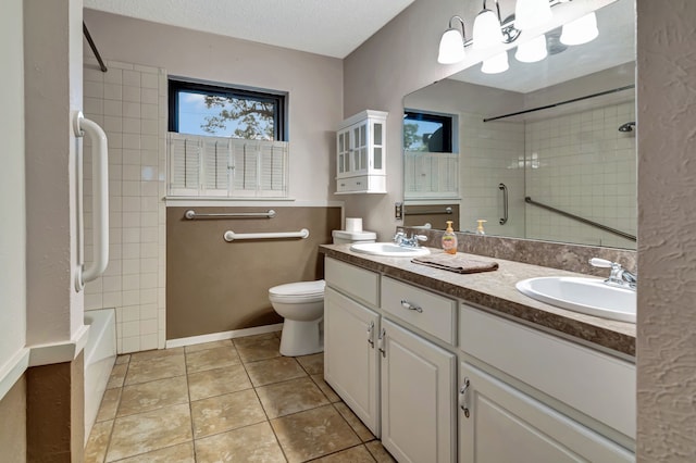 bathroom featuring toilet, tile patterned flooring, a sink, and double vanity