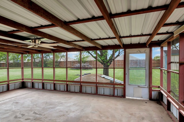 unfurnished sunroom featuring a ceiling fan